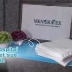 Global hospital bed sheet size guide showing folded white medical linens on a hospital trolley