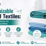 Promotional banner for Menora Tex featuring customizable medical textiles, stacked hospital linens in teal and blue shades, sewing machine, and highlights of custom design, durability, quality, and sustainable healthcare fabric solutions.